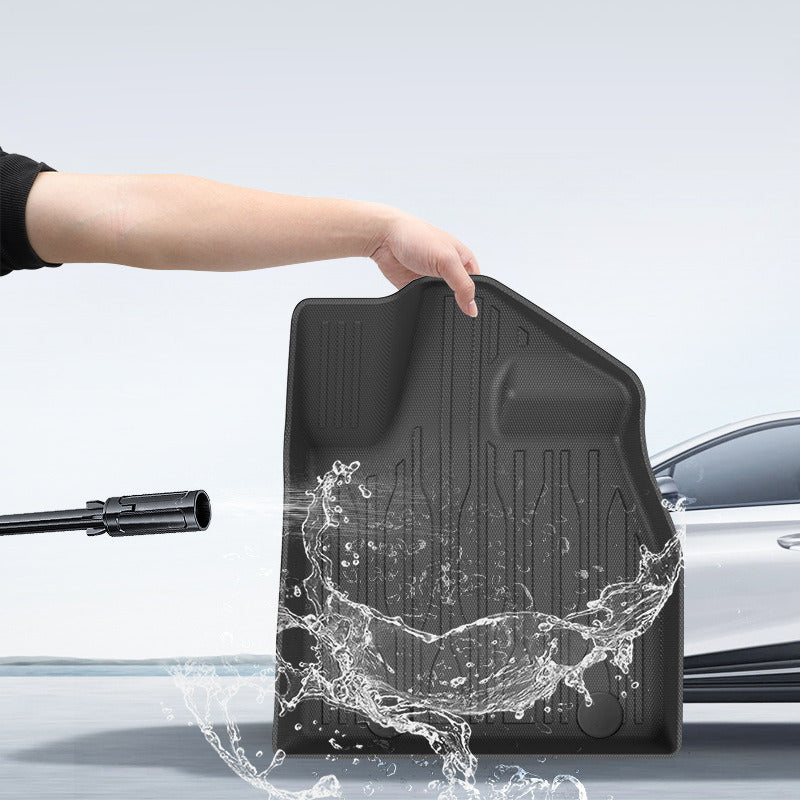BYD Sealion 6 floor mat being rinsed clean under running water