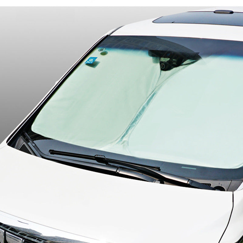 Silver front windscreen sunshade fitted in a car