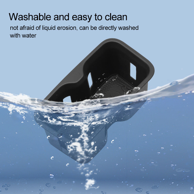 Cup holder insert being washed in water
