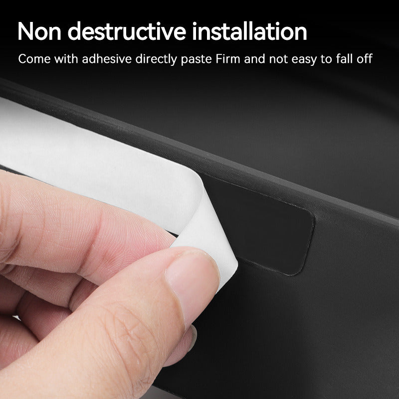 Peeling the adhesive backing to fit the storage box