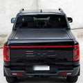 Electric roller lid tonneau cover on a black BYD Shark 6, rear view