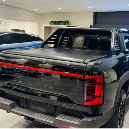 Electric roller lid tonneau cover on a black BYD Shark 6 with sports bar