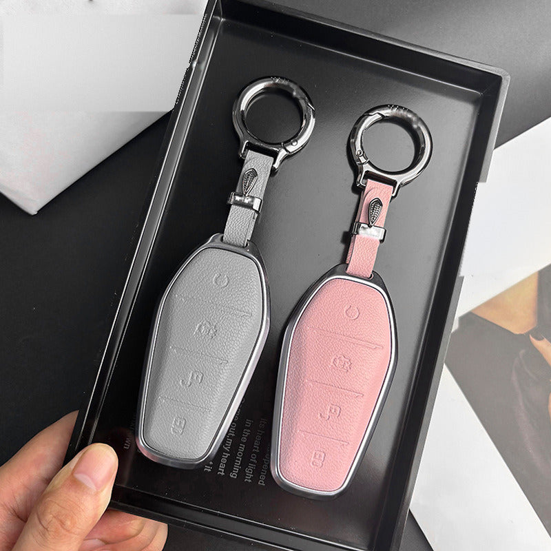 Leather BYD key cases in grey and pink with keychains