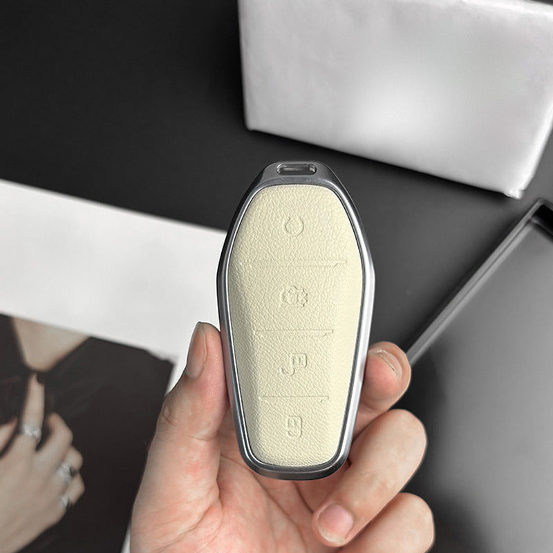 Cream leather BYD key case held in the hand