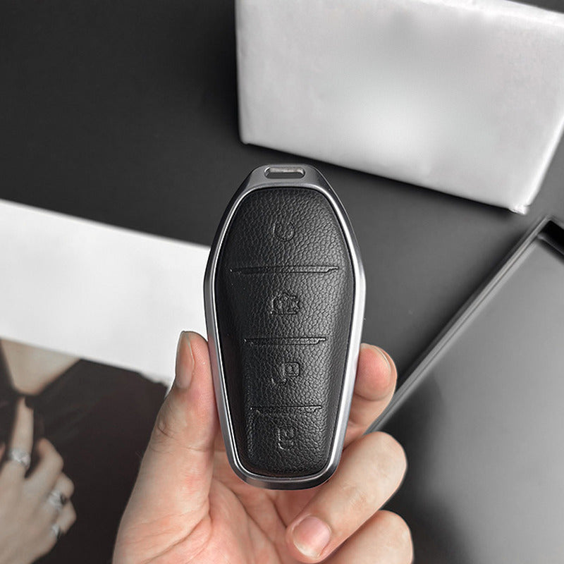 Black leather BYD key case held in the hand